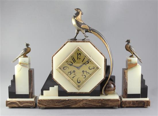 A 1930s onyx and hard stone mantel clock garniture, height 42cm